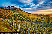  stock photography | Sunrise at La Morra, Cuneo, Piedmont, Italy, Image ID ITALY-PIEDMONT-0004. La Morra is a town blessed with the most beautiful position. The views from the town are wonderful. This is serious wine country with many Nebbiolo-Barolo vineyards and capable wine producers. The small, pretty village of La Morra is the focal point for what is in fact the largest commune in the appellation, both in terms of production and area under vine. The wines of La Morra have a reputation for elegance, perfume, and finesse, even if the reality is a little more complex. Given that there are 62 wineries physically located in La Morra, and many who vinify wine from the area elsewhere, it is unsurprising that La Morra plays host to a wide range of Barolo styles.