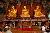 korea stock photography | In Prayer for Buddha Inside Jogyesa Temple in Seoul, South Korea, Gyeonji-dong, Jongno-gu, Seoul, South Korea, Image ID KR-SEOUL-JOGYESA-0006. 