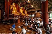 korea stock photography | In Prayer for Buddha Inside Jogyesa Temple in Seoul, South Korea, Gyeonji-dong, Jongno-gu, Seoul, South Korea, Image ID KR-SEOUL-JOGYESA-0009. 