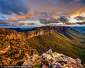 landscapes stock photography | Stormy Evening at Narrow Neck Plateau, Katoomba, Blue Mountains National Park, NSW, Australia. The Narrow Neck Plateau, an eroded remnant of a sandstone layer situated at an elevation of 1,000 metres (3,300 ft) above sea level that is part of the Blue Mountains Range which is a spur line off the Great Dividing Range, is situated immediately south-west of Katoomba in New South Wales, Australia, located within the Blue Mountains National Park. The neck separates the Jamison Valley (to the east) from the Megalong Valley (to the west). From Cliff Drive, Katoomba, the Narrow Neck is accessed via a dirt road called Glenraphael Drive suitable for most two-wheel drive vehicles, subject to good weather conditions, as far as a locked gate. It is a popular walking, bike riding and climbing location and offers several walking descent routes to the adjacent valleys. Beyond the gate is walking/bicycle access only for the general public. One of the most popular walks is the Golden Stairs, a rough descent of approximately 200 metres (660 ft) to join the Federal Pass. This opens up the Jamison Valley for popular day walks to sites such as Mount Solitary and the Ruined Castle. The neck juts southwards from Katoomba for a distance of some 10 kilometres (6.2 mi) and ends at Clear Hill, overlooking the Wild Dog Mountains. Castle Head promontory points towards the Ruined Castle, a small rock formation between Castle Head and Mount Solitary. Arguably one of the best views on the eastern seaboard of NSW is from Narrow Neck Fire Tower. On a day of high visibility it is possible to see from Mittagong in the south to Toronto in the north and a number of peak landforms in between. It also has excellent views back towards the escarpment at Katoomba.