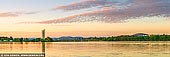 australia stock photography | National Carillon and Lake Burley Griffin at Sunrise, Canberra, Australian Capital Territory (ACT), Australia, Image ID AU-ACT-CANBERRA-0007. Located on Queen Elizabeth II Island (formerly known as Aspen Island), Lake Burley Griffin, the National Carillon was a gift from the British Government to the people of Australia to celebrate the 50th anniversary of the national capital. Carillons have a minimum of 23 bells. With 57 bronze bells the National Carillon is large by world standards. The pitch of the bells ranges chromatically through four and one half octaves. The bells each weigh between seven kilograms and six tonnes. Cast in England by John Taylor & Co of Loughborough, they are fine examples of the art of bellfounding. With the tower rising to a height of 50 metres, this allows the music of the bells to drift across Lake Burley Griffin and through Kings and Commonwealth Parks. The tower is lit at night, providing a magnificent landmark in the national capital. The best location to listen to the National Carillon is anywhere with an unobstructed view of the tower, within a radius of about 100 metres. The carillonist may be greeted at the base of the tower approximately five minutes after the recital.