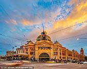australia stock photography | Flinders Street Station after Sunset, Melbourne, Victoria, Australia, Image ID AU-MELBOURNE-0026. Before Federation Square took the honours, Flinders Street Station was Melbourne's favourite meeting place, hence the catchphrase 'meet me under the clocks'. Flinders Street Station is Australia's oldest train station, and with its distinctive yellow facade and green copper dome it's a city icon. Takeaway stands line the concourse, and the upper floors were purpose-built to house a library, gym and a lecture hall, later used as a ballroom. Flinders Street is the busiest suburban railway station in the southern hemisphere, with over 1500 trains and 110,000 commuters passing through each day. Listed on the Victorian Heritage Register, its 708-metre main platform is the fourth longest railway platform in the world.
