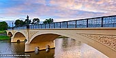 australia stock photography | Morell Bridge at Dawn, Melbourne, VIC, Australia, Image ID AU-MELBOURNE-0004. The beautiful Morell Bridge was built in 1899 and spans Yarra River in Melbourne, VIC, Australia. Completed by John Monash and J. T. N. Anderson, it is notable for being the first bridge in Victoria to be built using reinforced concrete. Located in a very picturesque part of the city, right beside The Royal Botanic Gardens, the bridge, which has also recently undergone a complete restoration, is closed to traffic and is now used as a pedestrian bridge. It features decorations on the three arch spans, including large dragon motifs and ornamental Victorian lights. The gutters on the bridge are cobbled bluestone, with a single lane bitumen strip running down the middle. The Bridge is listed on the Victorian Heritage Register. Originally known as the Anderson Street bridge, it was named the Morell Bridge in 1936 after Sir Stephen Morell who was a prominent Victorian businessman and Lord Mayor of Melbourne between 1926 and 1928.