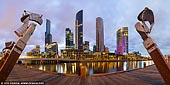 australia stock photography | Enterprize Landing and Southbank at Sunset, Enterprize Wharf, Melbourne, Victoria, Australia, Image ID AU-MELBOURNE-0011. Enterprize Wharf (also called Enterprize Landing) is the birthplace of Melbourne, when on Sunday 30th August 1835, settlers on the tall ship schooner Enterprize docked on this spot, thereby 'founding' Melbourne. On the landing are 5 statue figures staring out across the Yarra River turning basin along with a plaque commemorating the landing. The people came from Launceston in Van Diemens Land, and they were after land for grazing sheep. They were led by John Lancey, who was put in that position by John Pascoe Fawkner. Fawkner owned the boat, but did not sail on its first trip into the Port Phillip District because he was forced behind by creditors. They picked the site because there was a small waterfall, or rapids, that stopped further progress up the river. The waterfall also separated the tidal movement from fresh water at that site. The waterfall had previously been found and noted by the Colony of New South Wales' surveyor, Charles Grimes, in 1803.