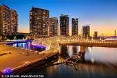 australia stock photography | Webb Bridge at Sunset, Docklands, Melbourne, Victoria, Australia, Image ID AU-MELBOURNE-0022. The Webb Bridge in Melbourne is the last pedestrian bridge over the Yarra River as part of a public art project in Melbourne's Docklands area. It was created by Denton, Corker & Marshall (DCM) in collaboration with artist Robert Owen, a distinguished Melbourne artist. The design received first prize in a limited design competition. The brief called for the re-use of the remaining sections of the Webb Dock Rail Bridge, in order to link the Docklands on the north side to the new residential developments on the south side.