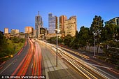 australia stock photography | Melbourne City at Sunrise, Batman Avenue, Melbourne, Victoria, Australia, Image ID AU-MELBOURNE-0023. Busy time in the morning on Batman Avenue in Melbourne, Victoria, Australia while cars, buses and trucks are coming to and from the city.