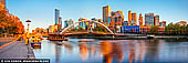 australia stock photography | Melbourne, Southbank Pedestrian Bridge and Flinders Street Station at Sunrise, Southbank, Melbourne, Victoria, Australia, Image ID AU-MELBOURNE-0034. Rainbow (also known as Southbank) Pedestrian Bridge is connecting Southgate to Flinders Street station, this iconic pedestrian bridge is one of the best places to snap a picture or enjoy the view in Melbourne. Marvel at the height of the Eureka Tower, wave to passing boats on the Yarra River, and watch trains hustle in and out of Flinders Street station. It was built in 1989, and as such is a relatively new pedestrian only crossing. It is a very busy thorough fare, with lots of foot traffic.