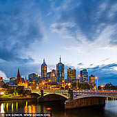 australia stock photography | Melbourne, Princes Bridge and Flinders Street Station at Dawn, Southbank, Melbourne, Victoria, Australia, Image ID AU-MELBOURNE-0035. Melbourne's grandest and oldest Bridge, Princes Bridge was styled on London's Blackfriars Bridge. Listed on the Victorian Heritage Register, Princes Bridge connects St Kilda Road to Swanston Street alongside Flinders Street Railway Station. A bridge has crossed the river at this point since 1845, the present Princes bridge being the third bridge across the Yarra at that location. The first two bridges built in 1845 (timber) and 1850 (stone) were built in response to a population explosion in Melbourne from several hundred to over 80 000 people, caused by the gold rush. In addition to the increase in traffic crossing the bridge, there was also a need to handle increased shipping traffic on the Yarra River and the river was widened to cope with this.