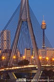 australia stock photography | Anzac Bridge and Sydney Tower at Twilight, Glebe, Sydney, NSW, Australia, Image ID AU-SYDNEY-ANZAC-BRIDGE-0011. Cars and vehicles are travelling to and from Sydney city via Anzac Bridge at the end of the day with blue night sky and buildings highlighted with golden light from street lanterns and sunset.