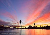 australia stock photography | Sunrise over Anzac Bridge, Glebe, Sydney, NSW, Australia, Image ID AU-SYDNEY-ANZAC-BRIDGE-0013. The vivid colours of the sunrise add to the beauty of the skyline in the City of Sydney in NSW, Australia. The appealing city of Sydney sits under a vivid sunrise in colors of blue, red and gold. The city of Sydney's skyline with its high rise buildings include the tall thin Centre Point Tower in the far distance and the Anzac Bridge in front spanning the Johnstons Bay between Pyrmont and Glebe Island.