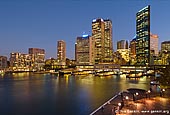 australia stock photography | Circular Quay at Night, Sydney, New South Wales (NSW), Australia, Image ID AU-SYDNEY-CIRCULAR-QUAY-0008. Stock image of Circular Quay ferry terminal and skyscrapers span the skyline of the Sydney city in Australia after sunset as seen from from Sydney Overseas Passenger Terminal.