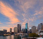 australia stock photography | Sunrise over Circular Quay, Sydney, New South Wales (NSW), Australia, Image ID AU-SYDNEY-CIRCULAR-QUAY-0012. Dramatic clouds highlighted by sunrise, hover above the Circular Quay and the Sydney city in New South Wales (NSW), Australia on a calm morning before peak time rush.