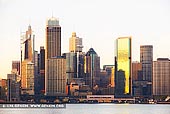 australia stock photography | Circular Quay and Sydney City at Dawn, Sydney, New South Wales (NSW), Australia, Image ID AU-SYDNEY-CIRCULAR-QUAY-0013. Skyscrapers at the Circular Quay in Sydney are glowing gold and yellow in the morning sunlight.