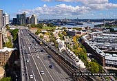 australia stock photography | Sydney City and The Bradfield Highway from Pylon Lookout, Sydney, NSW, Australia, Image ID AU-SYDNEY-0015. The Bradfield Highway in Sydney, NSW, Australia opened in 1932 and begins at the end of the Western Distributor in the Sydney CBD, crosses the Sydney Harbour Bridge and ends at the Warringah Freeway in North Sydney (just North of the Pacific Highway intersection). The Bradfield Highway carries six lanes of traffic across the eight lane Sydney Harbour Bridge. The other two traffic lanes on the Sydney Harbour Bridge are used for the Cahill Expressway, which run only southbound on the bridge. Dawes Point is a suburb of the City of Sydney, in the state of New South Wales, Australia. Dawes Point is located on the north-western edge of the Sydney central business district, at the southern end of Sydney Harbour Bridge, adjacent to The Rocks. Sections of Dawes Point have been included as part of the The Rocks area in the past and some residents and businesses still use it in their address. The area was originally known by the Aboriginal names of Tar-ra and Tullagalla. This was later changed to Point Maskelyne in honour of Reverend Dr Nevil Maskelyne, British Astronomer Royal. He sent out the first astronomical instruments which were established at the point in the country's first observatory, by Lieutenant William Dawes (1762-1836), astronomer with the First Fleet. The point was renamed in honour of Dawes.