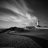 australia stock photography | The Macquarie Lighthouse, Sydney, NSW, Australia, Image ID AU-SYDNEY-0026. The Macquarie Lighthouse is Australia's first and longest operating navigational light. There has been a navigational aid on this site since 1791 and a lighthouse since 1818. It is also known as South Head Upper Light and it is located on Dunbar Head, Vaucluse, about 2 kilometres south of South Head near the entrance to Sydney Harbour. There has been a navigational aid in this vicinity since 1791 and a lighthouse near the present site since 1818. The current lighthouse was completed in 1883. The lighthouse is still fully operational and is under the control of the Australian Maritime Safety Authority. The grounds are managed by the Sydney Harbour Federation Trust.