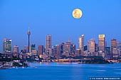 australia stock photography | Full Moon Over Sydney City, New South Wales (NSW), Australia, Image ID AU-SYDNEY-0027. A very large full moon glows in a yellow hue and rises above the Sydney city in New South Wales (NSW), Australia early in the morning right before sunrise. Warm and golden bright sky on East already reflected in skyscraper windows while the sky on West is still cold and blue.