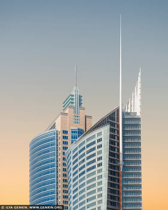 australia stock photography | Pastel Dawn over Sydney's Skyline Icons, Sydney, New South Wales (NSW), Australia. As the first light of day brushes the Sydney skyline, Aurora Place and Chifley Tower emerge like sculptural giants against a canvas of soft peach and blue. Their sleek, modern forms - curved glass and sharp spires - capture the elegance of contemporary architecture, glowing gently in the calm of morning. This image distills the essence of urban beauty, where geometry meets atmosphere, and light transforms steel into serenity. The pastel gradient sky adds a dreamlike softness to the commanding vertical lines, making this artwork ideal for refined interiors - from minimalist living spaces to modern corporate environments seeking calm and sophistication.