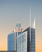 Pastel Dawn over Sydney's Skyline Icons - Fine art print of Sydney, New South Wales (NSW), Australia - As the first light of day brushes the Sydney skyline, Aurora Place and Chifley Tower emerge like sculptural giants against a canvas of soft peach and blue. Their sleek, modern forms - curved glass and sharp spires - capture the elegance of contemporary architecture, glowing gently in the calm of morning. This image distills the essence of urban beauty, where geometry meets atmosphere, and light transforms steel into serenity. The pastel gradient sky adds a dreamlike softness to the commanding vertical lines, making this artwork ideal for refined interiors - from minimalist living spaces to modern corporate environments seeking calm and sophistication. - Image ID: AU-SYDNEY-0040
