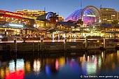 australia stock photography | Waterfront Promenade at Darling Harbour after Sunset, Sydney, NSW, Australia, Image ID AU-SYDNEY-DARLING-HARBOUR-0014. Harbourside Shopping Centre located on the waters edge of Darling Harbour, only a short walk from the CBD and with magnificent views of the city's skyline. Harbourside offers a unique dining, leisure and shopping experience. It also offers late night shopping every night with all stores open from 10am to 9pm every day. Selected cafes open earlier for breakfast as well as cafes, bars and restaurants open till late.