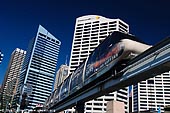 australia stock photography | Sydney City and Monorail, Darling Harbour, Sydney, New South Wales (NSW), Australia, Image ID AU-SYDNEY-DARLING-HARBOUR-0018. Sydney Monorail operates around the main retail area of the central business district (CBD or downtown) running down to Darling Harbour and skirting the harbour, before returning to the city area. A return trip is a good way of getting some perspective on the upper part of the central business district. It also gives you a great elevated look at picturesque Darling Harbour.