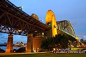australia stock photography | Sydney Harbour Bridge at Twilight from Bradfield Park, Sydney, New South Wales (NSW), Australia, Image ID AU-SYDNEY-HARBOUR-BRIDGE-0028. Sydney Harbour is world-renowned for its beauty and its famous Sydney Harbour Bridge. This is just one of seven magnificent bridges that complete the loop around the harbour. Every bridge has an interesting history behind it. Fondly known by locals as the 'Coat-hanger', the Sydney Harbour Bridge is one of Australia's best known and photographed landmarks. It is the world's largest (but not the longest) steel arch bridge with the top of the bridge standing 134 metres above the harbour.