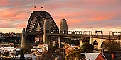 australia stock photography | Sydney Harbour Bridge at Dramatic Sunset, Observatory Hill, Sydney, New South Wales (NSW), Australia, Image ID AU-SYDNEY-HARBOUR-BRIDGE-0046. Panoramic image of The Sydney Harbour Bridge as it was seen from the Observatory Hill during dramatic yellow and pink sunset.