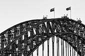 australia stock photography | Sydney Harbour Bridge Arches in Black and White, Sydney, New South Wales (NSW), Australia, Image ID AU-SYDNEY-HARBOUR-BRIDGE-0047. Silhouette of the beautiful Sydney Harbour Bridge steel arches in Sydney, NSW, Australia. The Sydney Harbour Bridge may not be the longest steel-arch Bridge in the world, but it is the largest and widest. At 48.8 metres (151.3 feet) wide, the Guinness Book of Records lists it as the widest long span Bridge in the world and until 1967, it was Sydney's tallest structure. The Sydney Harbour Bridge was not originally thought of as an arch bridge. Dr. John Job Crew Bradfield initially had a cantilever bridge in mind to span the harbour. However, on a trip to New York he was inspired by the Hell Gate Bridge and he realised the cantilever design was inferior to an arch for his proposed bridge.