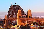 australia stock photography | Sydney Harbour Bridge at Sunset from Observatory Hill, Sydney, New South Wales (NSW), Australia, Image ID AU-SYDNEY-HARBOUR-BRIDGE-0006. Stock photo of the Sydney Harbour Bridge at sunset as it was seen from Observatory Hill in Sydney, NSW, Australia. Bushfires in National Parks polluted air with smoke which and created a very bright red and orange colours at sunset.