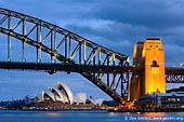 australia stock photography | Sydney Harbour Bridge and Opera House at Night, Sydney, New South Wales (NSW), Australia, Image ID AU-SYDNEY-HARBOUR-BRIDGE-0011. The Sydney Harbour Bridge is one of Australia's most famous icons. It is an engineering marvel and has been influential in determining the pattern of Sydney's growth. Today the Sydney Harbour Bridge carries eight traffic lanes and two railroad lines. There is a pedestrian pathway on the eastern side of the bridge and a cycleway on the western side of the bridge. When looking east from the Blues Point the Harbour Bridge makes a nice frame for another Sydney's icon - Sydney Opera House.