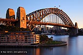 australia stock photography | Sydney Harbour Bridge and The Park Hyatt Hotel at sunrise, Sydney, New South Wales (NSW), Australia, Image ID AU-SYDNEY-HARBOUR-BRIDGE-0015. Stock image of the Sydney Harbour Bridge and The Park Hyatt Hotel highlighted by sunrise early in the morning in Sydney, NSW, Australia.