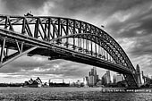 australia stock photography | Sydney Harbour Bridge and Opera House, Sydney, New South Wales (NSW), Australia, Image ID AU-SYDNEY-HARBOUR-BRIDGE-0021. Milsons Point is one of the places with spectacular views of the Opera House, Harbour Bridge and the rest of Sydney. This dramatic beautiful black and white photo of the Sydney Harbour Bridge (Sydney's greatest tourism icon) together with another Sydney's icon - the Opera House was created near Luna Park at Milsons Point.