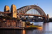 australia stock photography | Sydney Harbour Bridge and The Park Hyatt Hotel in the Morning, Sydney, New South Wales (NSW), Australia, Image ID AU-SYDNEY-HARBOUR-BRIDGE-0022. The iconic Park Hyatt Sydney Hotel is located in the historic Rocks precinct next to the Sydney Harbour Bridge with a view across the harbour towards the Sydney Opera House. The hotel re-opened in early 2012 after being closed for almost a year for an upgrade. The new contemporary interior design takes it's influence from the surrounding Rocks.