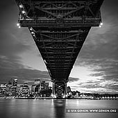 australia stock photography | Under The Harbour Bridge, Sydney, New South Wales (NSW), Australia, Image ID AU-SYDNEY-HARBOUR-BRIDGE-0026. Beautiful black and white photo of the Sydney Harbour Bridge steel structures and Sydney city at night, shot right from under the bridge at Milsons Point in Sydney, New South Wales, Australia.