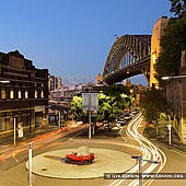 australia stock photography | Harbour Bridge at Night from The Wharf Theatre, Sydney, New South Wales (NSW), Australia, Image ID AU-SYDNEY-HARBOUR-BRIDGE-0030. Night photo of the sculpture by Jimmie Durham, called Still Life With Stone and Car, at the corner of Hickson Road and Pottinger Street in Dawes Point in Sydney, NSW, Australia with the Sydney Harbour Bridge in the background.
