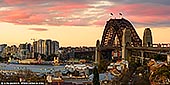 australia stock photography | Sydney Harbour Bridge and Vivid Sunset, Observatory Hill, Sydney, New South Wales (NSW), Australia, Image ID AU-SYDNEY-HARBOUR-BRIDGE-0042. Panoramic image of The Sydney Harbour Bridge as it was seen from the Observatory Hill during vivid yellow and pink sunset.