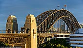 australia stock photography | Sydney Harbour Bridge from Milson's Point, Sydney, New South Wales (NSW), Australia, Image ID AU-SYDNEY-HARBOUR-BRIDGE-0043. Close-up image of the Sydney Harbour Bridge from Milson's Point train station when last rays of the low Sun highlighted the bridge while dark stormy clouds in the background created dramatic effect.