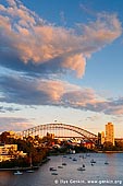 australia stock photography | Sydney Harbour Bridge at Sunset, Waverton, Sydney, NSW, Australia, Image ID AU-SYDNEY-HARBOUR-BRIDGE-0048. Dramatic clouds highlighted by sunset, hover above Sydney Harbour Bridge in Sydney, NSW, Australia. This gorgeous scenery was captured from the Larkin Street Lookout in Waverton and it is just one of the elements that attracts visitors to this viewpoint. Watching a sunset can be a peaceful and self-reflecting experience. Many couples like to watch sunsets together as they are often considered a romantic occurrence and have a magical element to them.