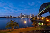 australia stock photography | Sydney CBD Skyline with the Opera House and Harbour Bridge at Dawn, Kirribilli, Sydney, NSW, Australia, Image ID AU-SYDNEY-OPERA-HOUSE-0011. Stock image of Sydney Opera House and Harbour Bridge at Dawn, Sydney, NSW, Australia. This photo was taken from the harbour shore in the Kirribilli suburb, which has fantastic views across the harbour to Sydney Harbour Bridge, Opera House and Sydney city.