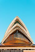 Symphony of Light: Sydney Opera House in Stillness - Fine art print of Sydney, New South Wales (NSW), Australia - In this minimalist portrait of the Sydney Opera House, the iconic sails rise with sculptural elegance against a flawless blue sky, their geometry mirrored in tranquil harbour reflections below. Captured from a perfect frontal perspective, the image emphasises the harmony between form, light, and architectural rhythm. Warm golden hues glint through the layered glass and steel, hinting at the dynamic energy within, while the composition remains serenely still - almost meditative in its symmetry. This fine art print evokes both strength and grace, making it an ideal statement piece for modern interiors, creative studios, or serene office spaces seeking balance and inspiration. - Image ID: AU-SYDNEY-OPERA-HOUSE-0050