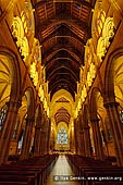 australia stock photography | St. Mary's Cathedral, Sydney, NSW, Australia, Image ID AU-SYDNEY-ST-MARYS-CATHEDRAL-0002. In cross-section the St. Mary's Cathedral in Sydney, NSW, Australia is typical of most large churches in having a high central nave and an aisle on either side, which serve to buttress the nave and provide passage around the interior. The interior of the nave thus rises in three stages, the arcade, the gallery and the clerestory which has windows to light the nave. The building is of golden-coloured sandstone which has weathered externally to golden-brown. The roof is of red cedar, that of the nave being of an open arch-braced construction enlivened by decorative pierced carvings. The chancel is vaulted with timber, which was probably intended to be richly decorated in red, blue and gold after the manner of the wooden roof at Peterborough, but this did not eventuate, and the warm colour of the timber contrasts well with the stonework.