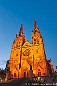 australia stock photography | St. Mary's Cathedral at Night, Sydney, NSW, Australia, Image ID AU-SYDNEY-ST-MARYS-CATHEDRAL-0003. Despite the many English features of the architecture including its interior and chancel termination, the entrance facade of the St. Mary's Cathedral in Sydney, NSW, Australia is not English at all. It is a design loosely based on the most famous of all Gothic west fronts, that of Notre Dame de Paris with its balance of vertical and horizontal features, its three huge portals and its central rose window. There are two more large rose windows, one in each of the transepts. The French facade was, however, intended to have twin stone spires like those of Lichfield Cathedral, but they were not to be put in place until 132 years after the building was commenced.