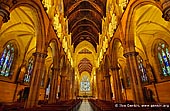 australia stock photography | St. Mary's Cathedral Interior, Sydney, NSW, Australia, Image ID AU-SYDNEY-ST-MARYS-CATHEDRAL-0004. The side aisles in St. Mary's Cathedral in Sydney, NSW, Australia are vaulted in stone, with a large round boss at the centre of each ribbed vault. Children who, over the years, have crawled into the arched space beneath the pulpit have discovered another such beautiful carved boss, in miniature and usually unseen. On all the terminals of arches within the buildings are carved heads of saints. Those that are near the confessionals are at eye-level and may be examined for their details. The screen behind the high altar is delicately carved in Oamaru limestone from New Zealand. It contains many open niches, but these, like the similar niches in the altar of Our Lady located directly behind the high altar, are empty and the statues have never been completed. There are two large chapels and two smaller ones, the larger being the Chapel of the Sacred Heart and the Chapel of the Irish Saints. On either side of the Lady Chapel are the Chapels of Ss Joseph and Peter all with ornately carved altars and a small statue in each niche. The embellished mosaics in the Kelly Chapel floor were laid by Melocco Co in 1937 approximately the same time as the mosaic floor in the Lady Chapel of St John's College also designed by Wardell.