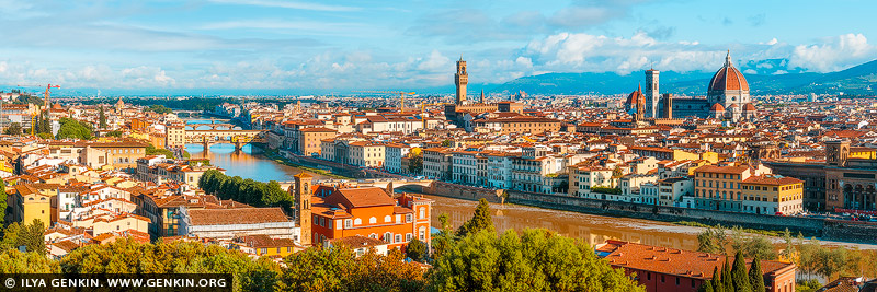 italy stock photography | Panorama of Florence at Sunrise, Florence, Tuscany, Italy. A breathtaking panoramic view of Florence captured from Piazzale Michelangelo at dawn. The city lies quietly beneath a golden veil as the rising sun casts warm light over the terracotta rooftops, the graceful dome of the Duomo, and the winding Arno River. Morning mist lingers softly around the distant Tuscan hills, adding a dreamlike quality to the scene. The light shimmers off the Ponte Vecchio, and the entire city glows with the serene elegance of a Renaissance painting come to life. This moment is a perfect harmony of history, architecture, and natural beauty awakened by the first light of day.