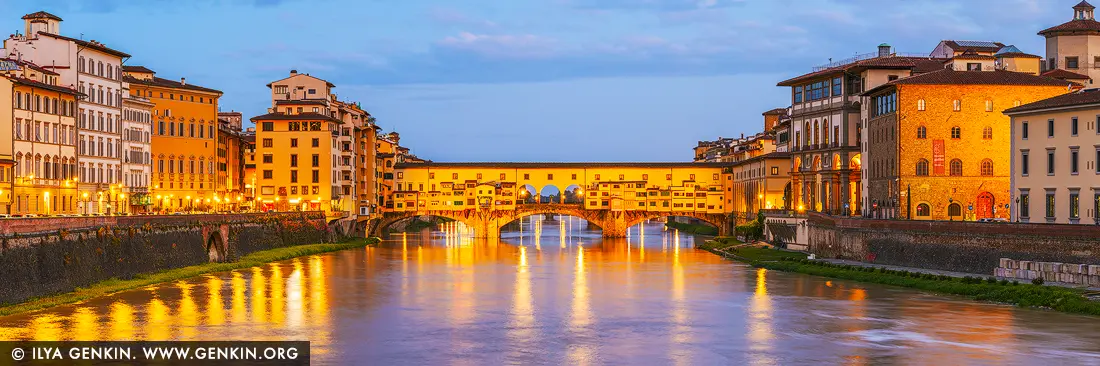 Golden Reflections on the Arno - Ponte Vecchio at Dawn - Fine art print of Florence, Tuscany, Italy - As dawn gently awakens Florence, the Ponte Vecchio glows in a warm cascade of golden light, mirrored in the still waters of the Arno River. This iconic medieval bridge, lined with timeless shops and steeped in centuries of artistry, becomes a radiant focal point in the early morning calm. The soft pastel sky contrasts beautifully with the luminous façades of the riverside buildings, creating a moment of serene elegance that feels both historic and intimate. This fine art photograph captures not just a cityscape, but a feeling - one of quiet grandeur, old-world romance, and Florentine charm. Perfect for elevating a living room, study, or hallway with a sense of European sophistication and gentle tranquility. - Image ID: ITALY-FLORENCE-0002