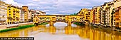 Timeless Charm of Ponte Vecchio in Soft Light - Fine art print of Florence, Tuscany, Italy - Under a canopy of soft, cloud-strewn skies, the Ponte Vecchio stretches gracefully across the golden-tinted Arno River, glowing with centuries of Florentine history. The rich yellows and warm ochres of the historic buildings lining the bridge and riverbanks seem to hum with quiet elegance. In this panoramic composition, the timeless architecture draws the eye toward the heart of Renaissance Florence - a place where artisans once traded gold and dreams. The gentle light, mirrored in the calm waters below, evokes a feeling of warmth and nostalgia. This artwork brings a refined, European touch to any interior - ideal for adding character and cultured beauty to a living space or office. - Image ID: ITALY-FLORENCE-0003