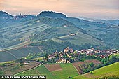  stock photography | Hills of Barolo in the Morning, Cuneo, Piedmont, Italy, Image ID ITALY-PIEDMONT-0003. The township of Barolo is located in the Langhe hills south of the truffle capital Alba in the Cuneo province of Piedmont, and functions both physically and metaphorically as the heart of the region. The village of Barolo has given name to the wines, and the 750 inhabitants receive a very large number of tourists. They come to taste the grapes and see the wine museum WiMu that has been established in a thousand year old castle. There's also a charming cork screw museum, and several cafes, restaurants and wine bars. Unlike most of the other villages in the area, Barolo is not located on a hilltop but halfway down an valley.