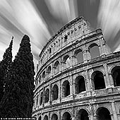 Timeless Majesty: The Colosseum in Motion - Fine art print of Rome, Lazio, Italy - Swept by streaking clouds and bathed in monochrome drama, this long exposure captures the Colosseum not as a ruin, but as a living monument - defiant, eternal, and etched into the soul of Rome. The ancient arches rise with quiet power, their weathered stones speaking of emperors, crowds, and centuries of spectacle. The tall cypress trees anchor the frame, whispering of Italian elegance and continuity. In black and white, every detail becomes elemental: form, contrast, history, and light. This fine art photograph evokes a sense of grandeur and stillness in motion - ideal for refined interiors seeking a timeless statement of culture and strength. - Image ID: ITALY-ROME-COLOSSEUM-0002