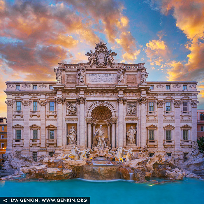 italy stock photography | Fontana di Trevi and Palazzo Poli at Sunrise, Rome, Lazio, Italy. Bathed in the fiery hues of a Roman dawn, the Trevi Fountain awakens in golden silence. The marble figures of Oceanus and his Tritons glow with warmth as the first rays of sunlight spill across the Piazza, igniting the cascading water with shades of amber and rose. Behind the fountain, the grand facade of the Palazzo Poli stands dignified and radiant, its Baroque details softened by the morning light. The usual crowds have yet to arrive, leaving the scene serene and timeless - a rare, dreamlike moment in the Eternal City where history, art, and light converge. The Trevi Fountain or Fontana di Trevi in Italian is an 18th-century fountain in the Trevi district in Rome, Italy, designed by Italian architect Nicola Salvi and completed by Giuseppe Pannini in 1762 and several others. Standing 26.3 metres (86 ft) high and 49.15 metres (161.3 ft) wide, it is the largest Baroque fountain in the city and one of the most famous fountains in the world. The origins of the fountain go back to the year 19 B.C., in which period the fountain formed the end of the Aqua Virgo aqueduct. The first fountain was built during the Renaissance, under the direction of Pope Nicholas V. Interestingly enough, the name of Trevi derives from Tre Vie (three ways), since the fountain was the meeting point of three streets. The building directly behind the Trevi Fountain in Rome is the Palazzo Poli. This historic palace, originally constructed in the 16th century and expanded in the 18th century, was specifically altered to serve as the monumental backdrop for the fountain. The Baroque south facade of Palazzo Poli was designed by architect Luigi Vanvitelli under the direction of Nicola Salvi, the creator of the Trevi Fountain, to integrate the fountain seamlessly into the palace's structure. Today, Palazzo Poli houses the Central Institute for Graphics (Istituto Centrale per la Grafica), and its grand Sala Dante offers exceptional views over the Trevi Fountain. The palace has a rich history, having been owned and renovated by several prominent families, and remains an important cultural and architectural landmark in Rome.