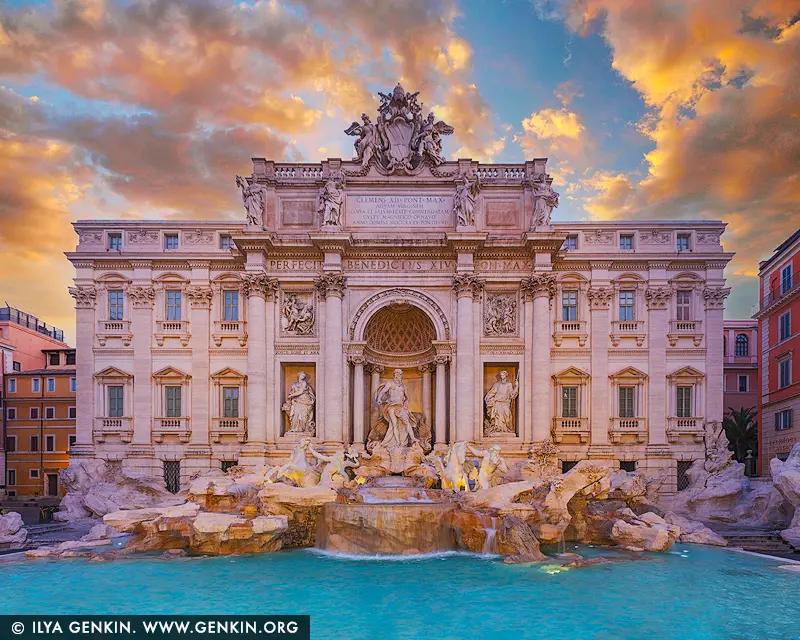 italy stock photography | Radiance of Dawn at the Trevi Fountain, Rome, Lazio, Italy. Bathed in the tender glow of sunrise, the Trevi Fountain and the grand façade of Palazzo Poli radiate an ethereal beauty that feels almost mythical. The sky ignites in a mosaic of soft gold and rose, casting gentle reflections across the turquoise waters below. Neptune, framed by baroque grandeur, emerges from stone and sea with commanding grace - a timeless symbol of Rome's artistic majesty. In the hush of early morning, before the crowds stir, the fountain becomes a sacred space of serenity and wonder. This artwork captures the soul of Rome at its most poetic, bringing a sense of light, opulence, and classical romance to any space - ideal for refined interiors, especially in a bedroom or reading room where calm and inspiration are desired.