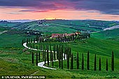  stock photography | Sunset at Baccoleno, Crete Senesi, Tuscany, Italy, Image ID ITALY-TUSCANY-0001. One of the classic shots from Tuscany is this view of Baccoleno Farmhouse (Agriturismo). This is one of the most photographed not only of the Crete Senesi but of all Tuscany. This is the famous road lined with cypress trees with a characteristic 'S' shape. One of the most famous photos on postcards, desktops and calendars. A wonderful village situated at the top of one of the gentle hills which follow one another in the heart of the Crete Senesi. From every corner of the building there are views that take one's breath away. Baccoleno is everyone's Tuscan dream; it has a wonderful view, an evocative atmosphere, nicely furnished apartments and a swimming pool with a 'convertible' function.